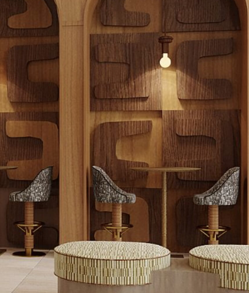 Co-working alcoves in the lobby at The Code Austin with sculpted wood walls, a high-top table, and three chairs with brass footrests.