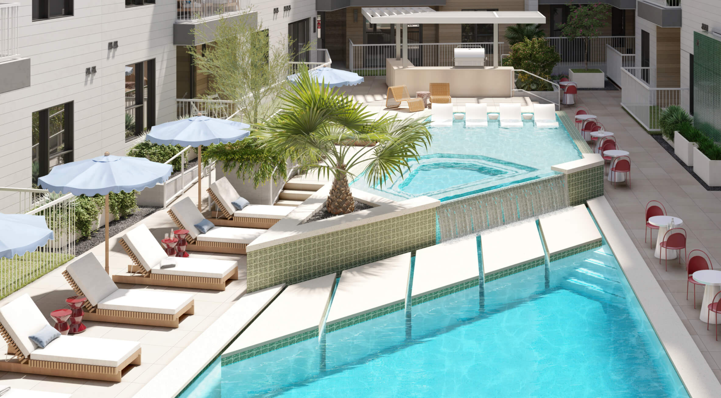Two-tiered courtyard pool at The Code Austin with an infinity edge spilling into a lower pool, surrounded by loungers, umbrellas, and tables.